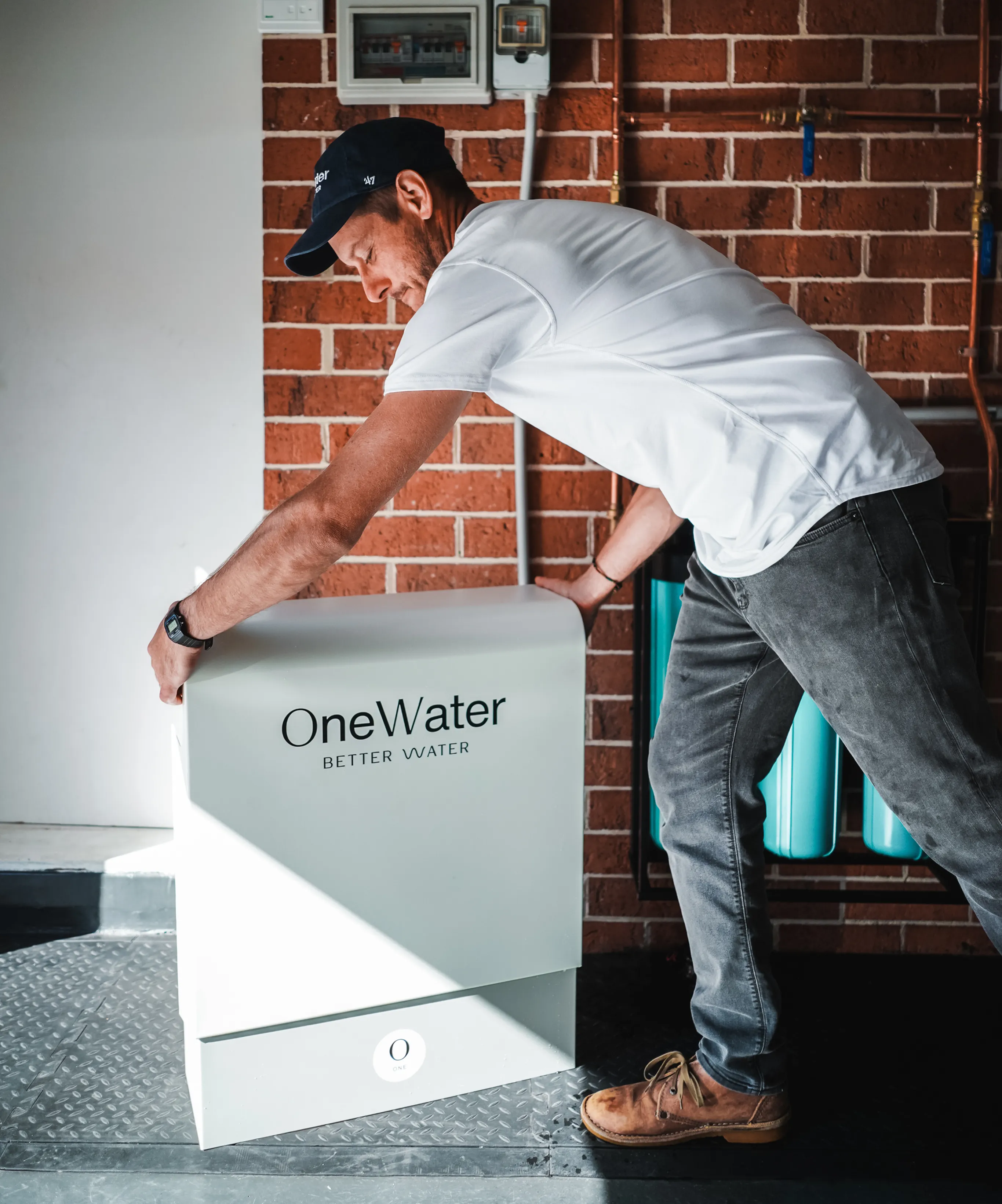 Australian family at kitchen sink enjoying purified water from OneWater system