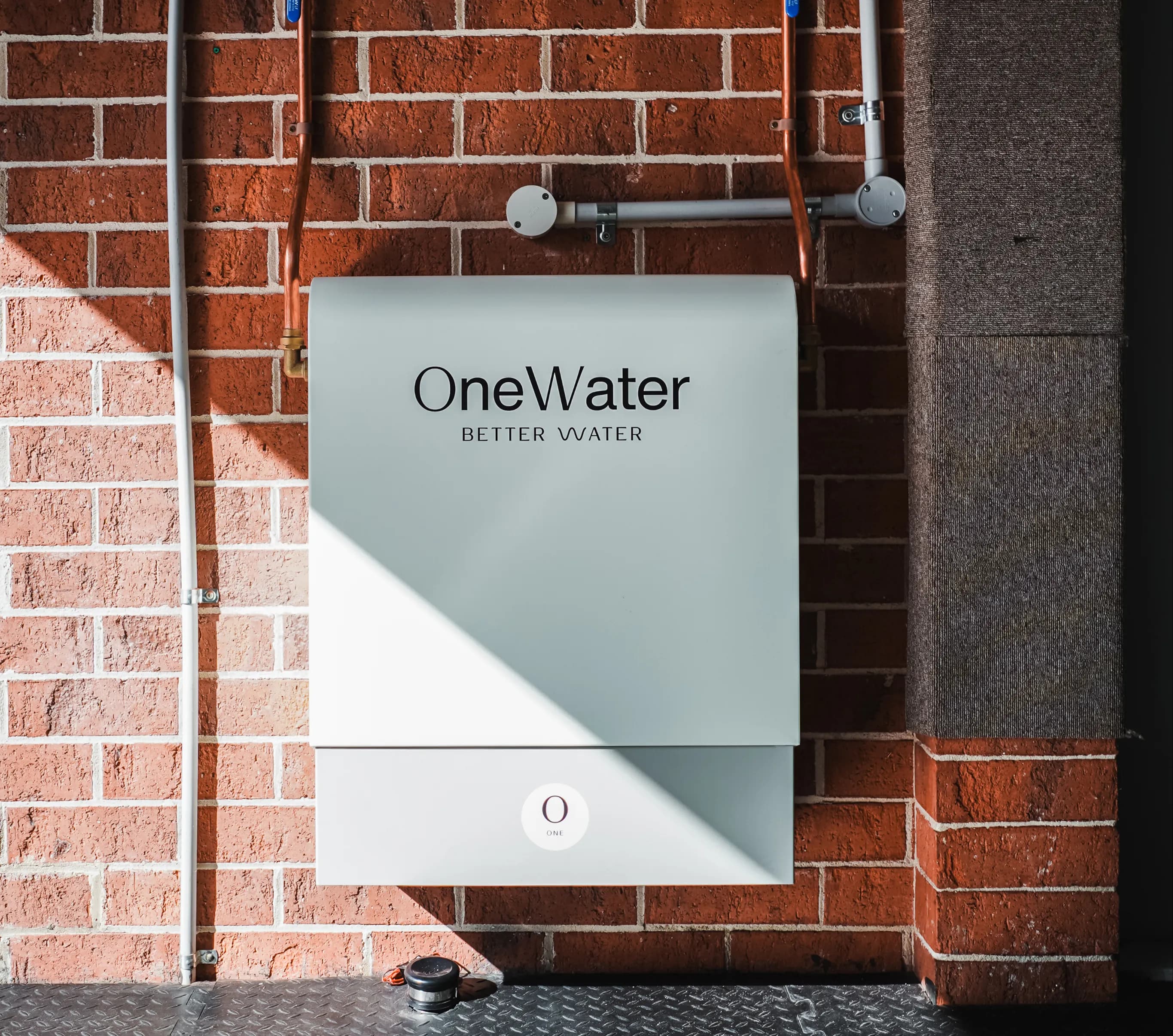 Australian family at kitchen sink enjoying purified water from OneWater system