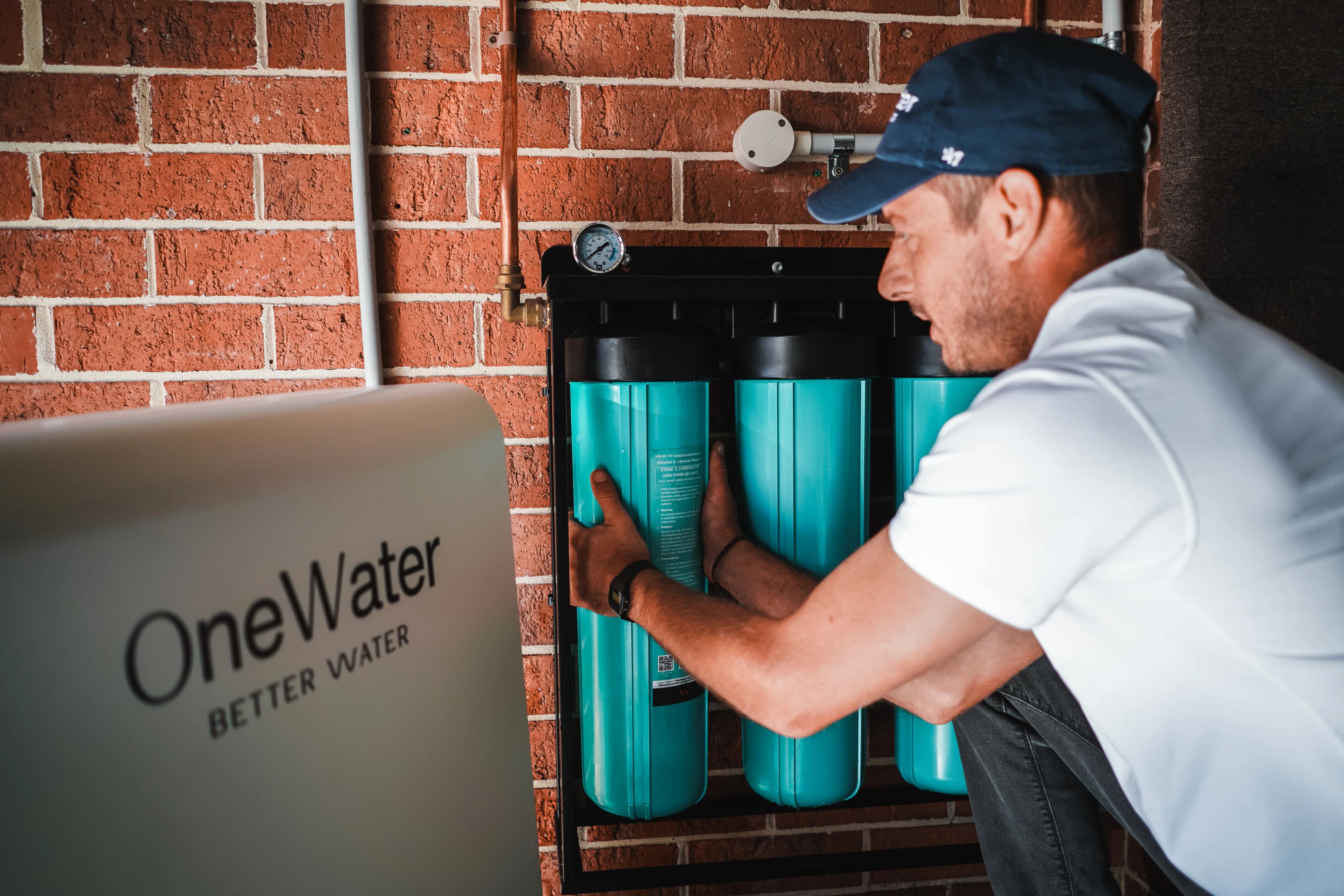 OneWater whole-home water filtration system installed in a modern Australian kitchen